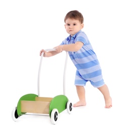 Photo of Cute baby playing with toy walker on white background