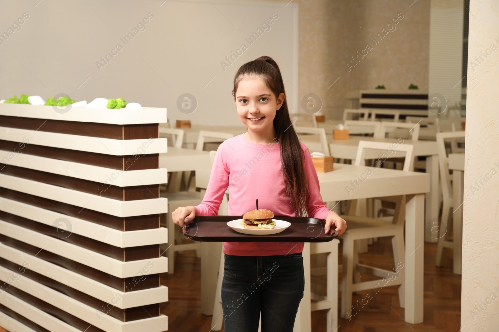 Photo of Little girl with tasty food in school canteen