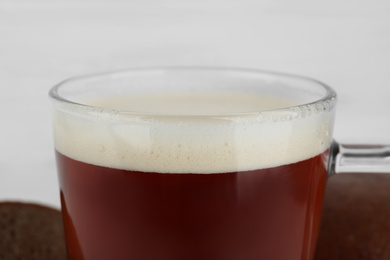 Glass of delicious kvass on blurred background, closeup