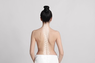 Image of Woman with healthy back on light background. Illustration of spine