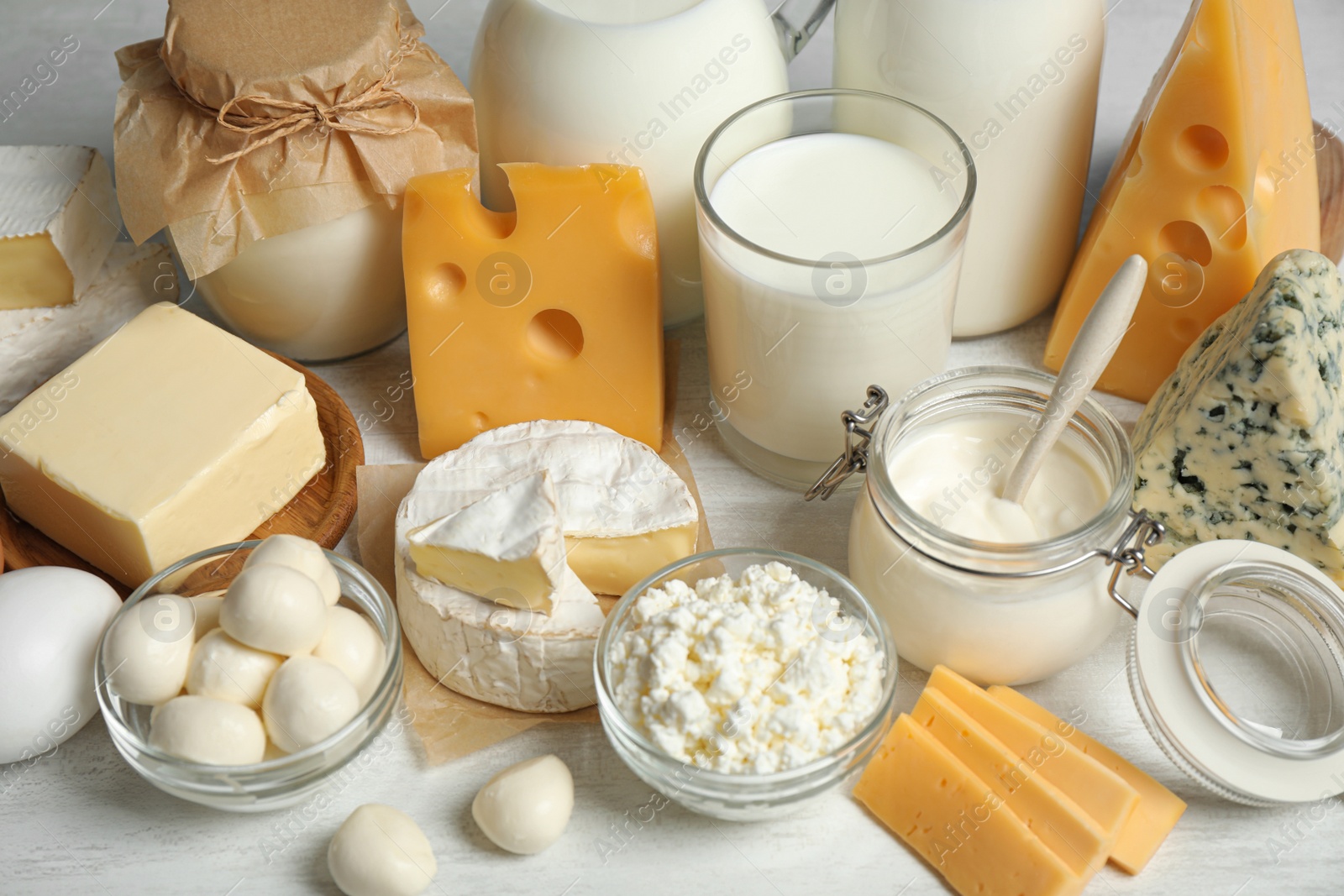 Photo of Different delicious dairy products on white table