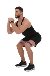 Young man exercising with elastic resistance band on white background