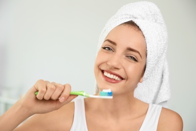 Photo of Portrait of young woman with toothbrush on blurred background