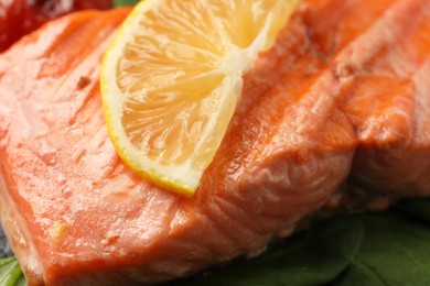 Photo of Tasty grilled salmon with lemon, closeup view
