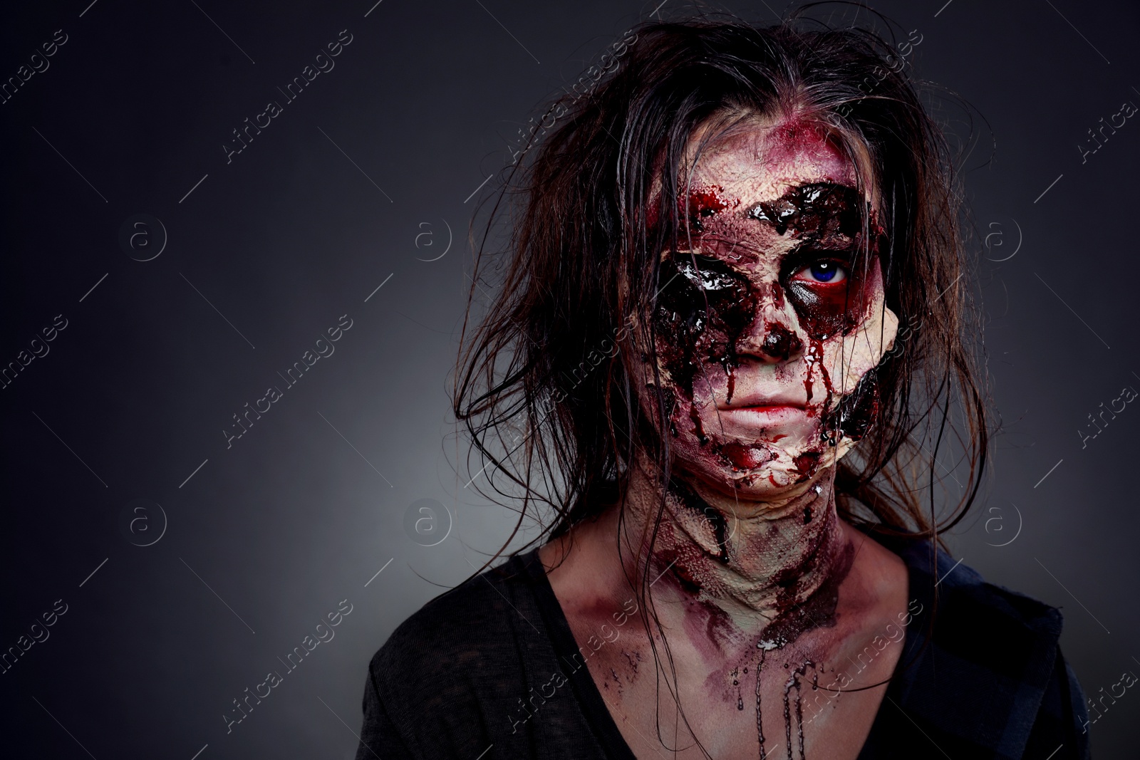 Photo of Scary zombie on dark background, space for text. Halloween monster