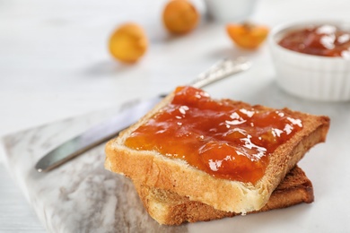 Photo of Bread with tasty apricot jam on board