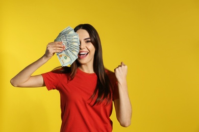 Photo of Young woman with money on color background. Space for text