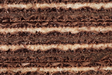 Photo of Delicious chocolate wafer sticks as background, closeup. Sweet food