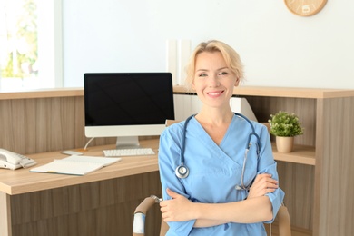 Photo of Female medical assistant at workplace in clinic. Health care service