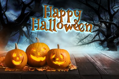 Image of Happy Halloween. Scary Jack O`Lantern pumpkins surrounded by mystical fog in night