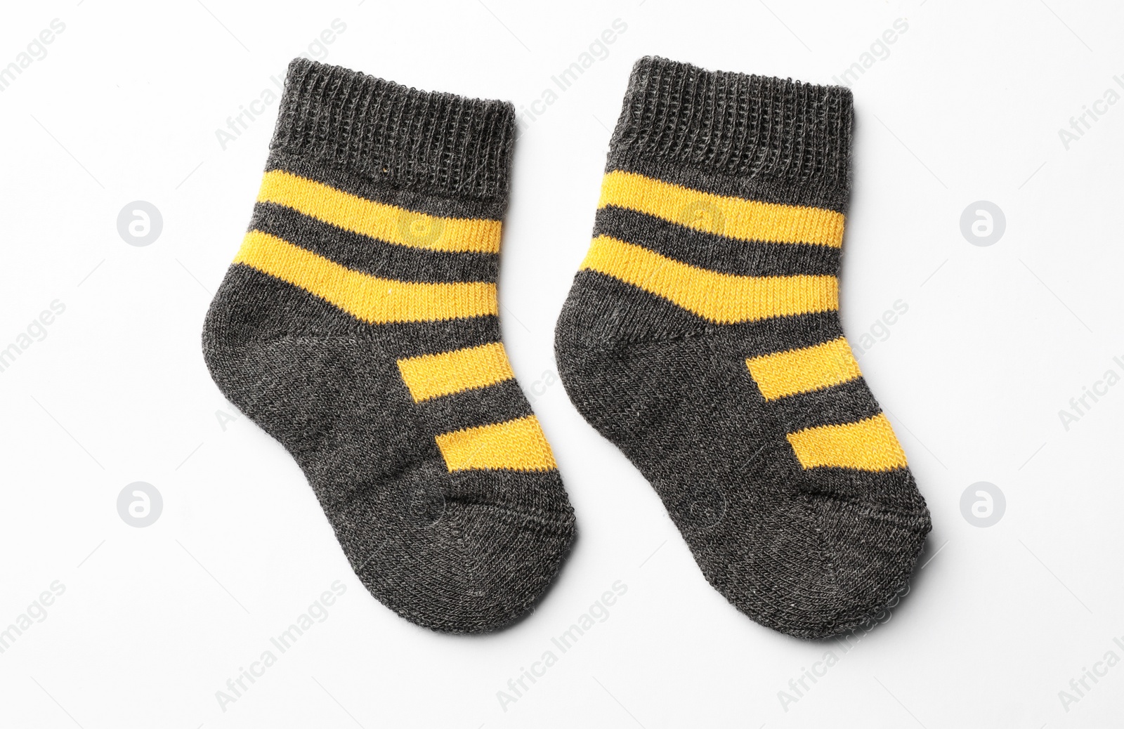 Photo of Cute child socks on white background, top view