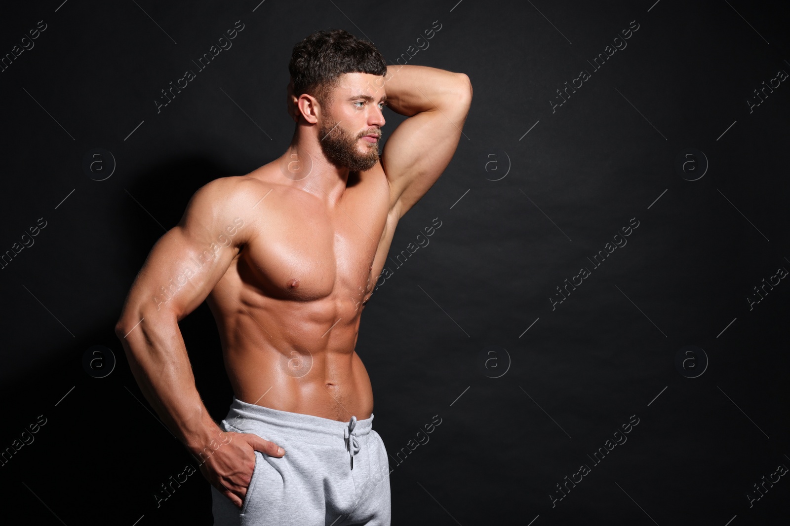 Photo of Handsome muscular man on black background, space for text. Sexy body