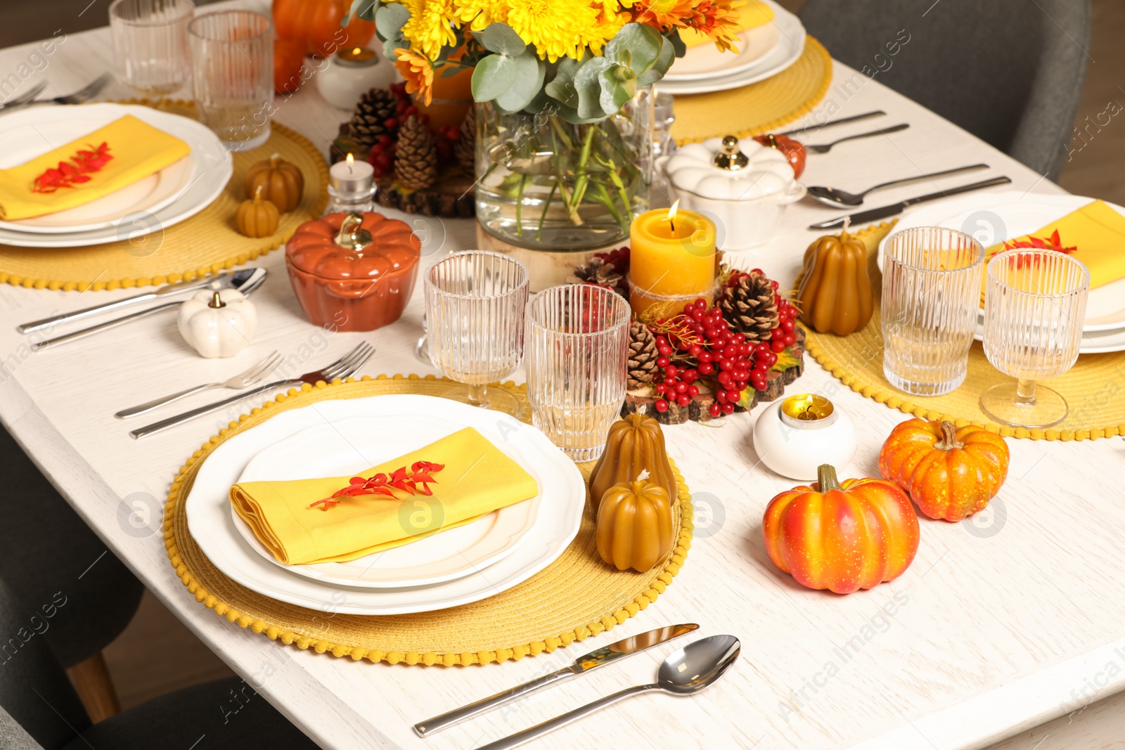 Photo of Autumn table setting with floral decor and pumpkins indoors