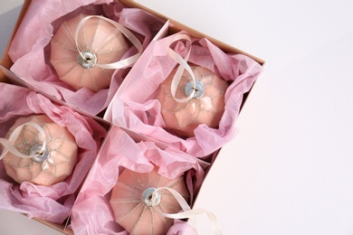 Photo of Beautiful Christmas baubles in box on white background, top view