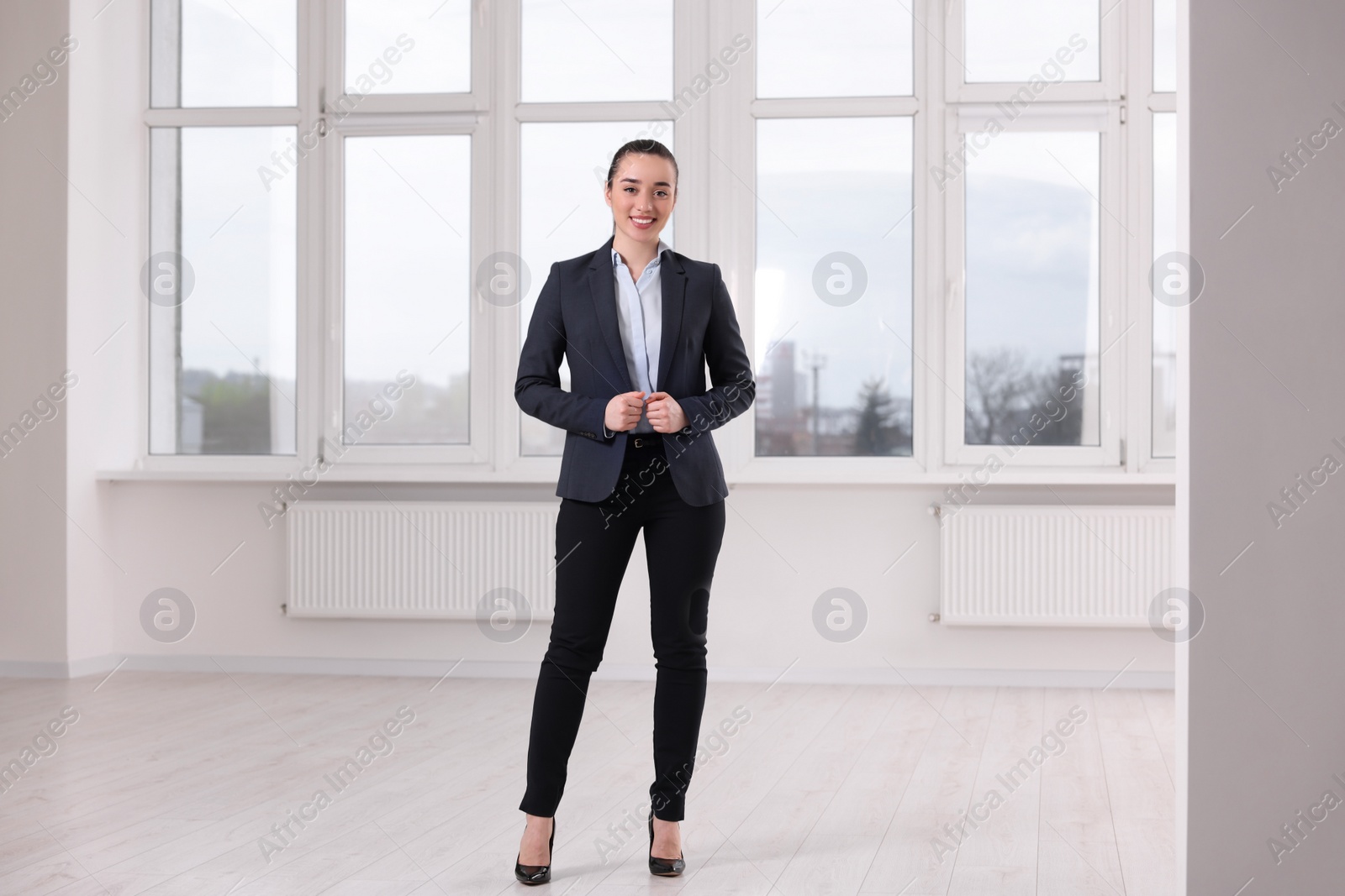 Photo of Happy real estate agent in new apartment