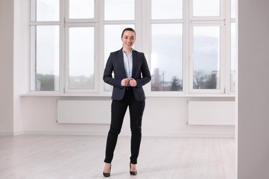 Happy real estate agent in new apartment