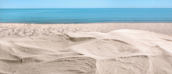 Image of Beautiful beach with white sand near ocean, closeup view. Banner design