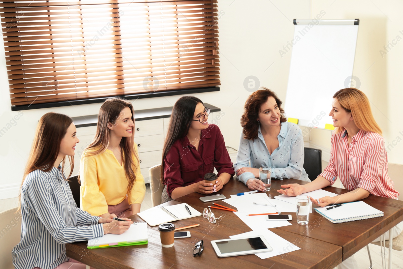 Photo of Female professional business team working in office. Women power concept