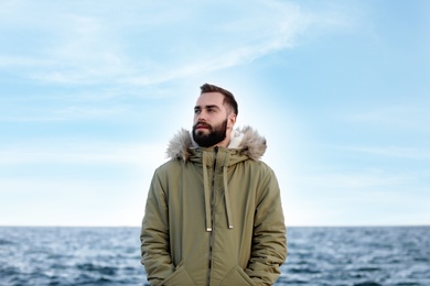 Portrait of handsome young man near sea