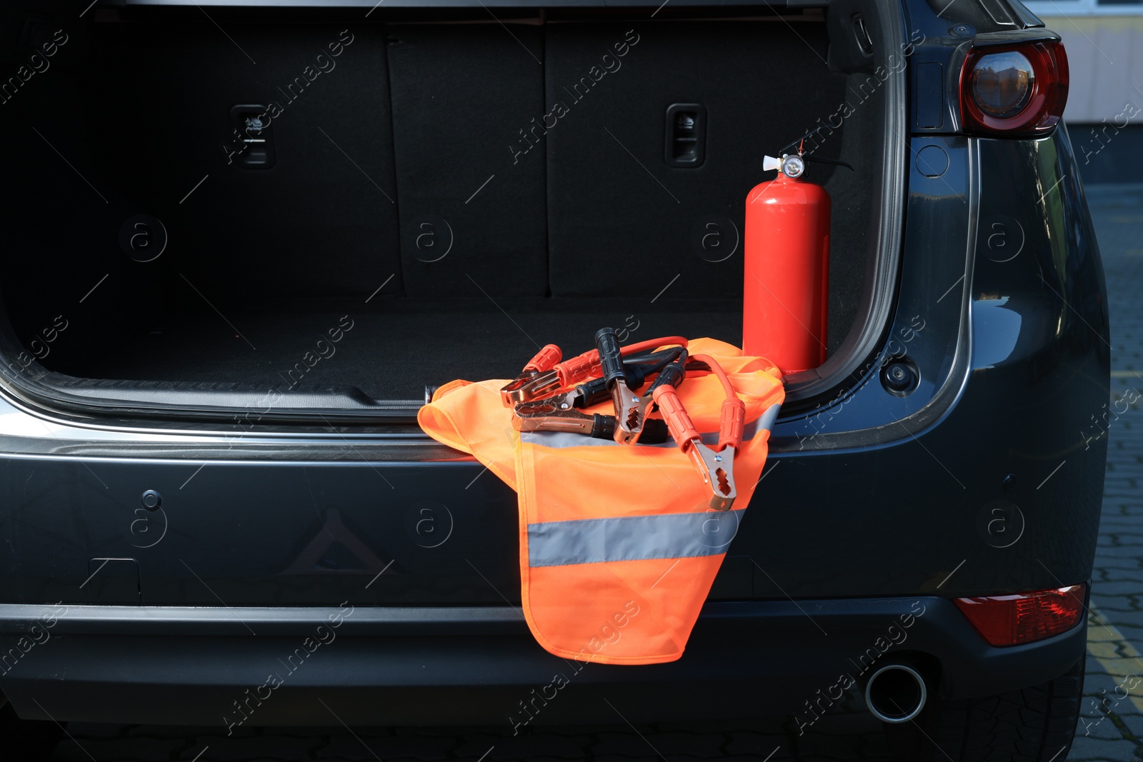 Photo of Set of car safety equipment in trunk, space for text