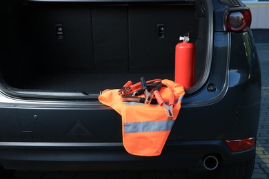 Set of car safety equipment in trunk, space for text