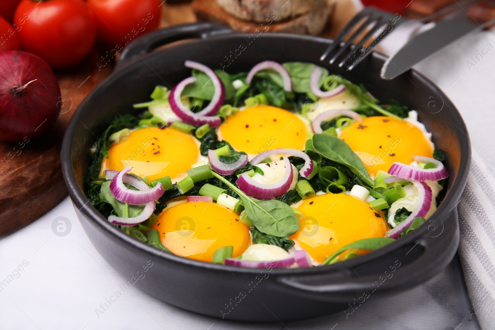 Photo of Tasty Shakshouka served on white table, closeup