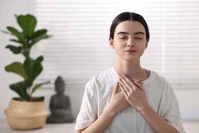 Photo of Portrait of beautiful girl meditating in yoga studio