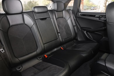 Clean leather seats inside of modern black car