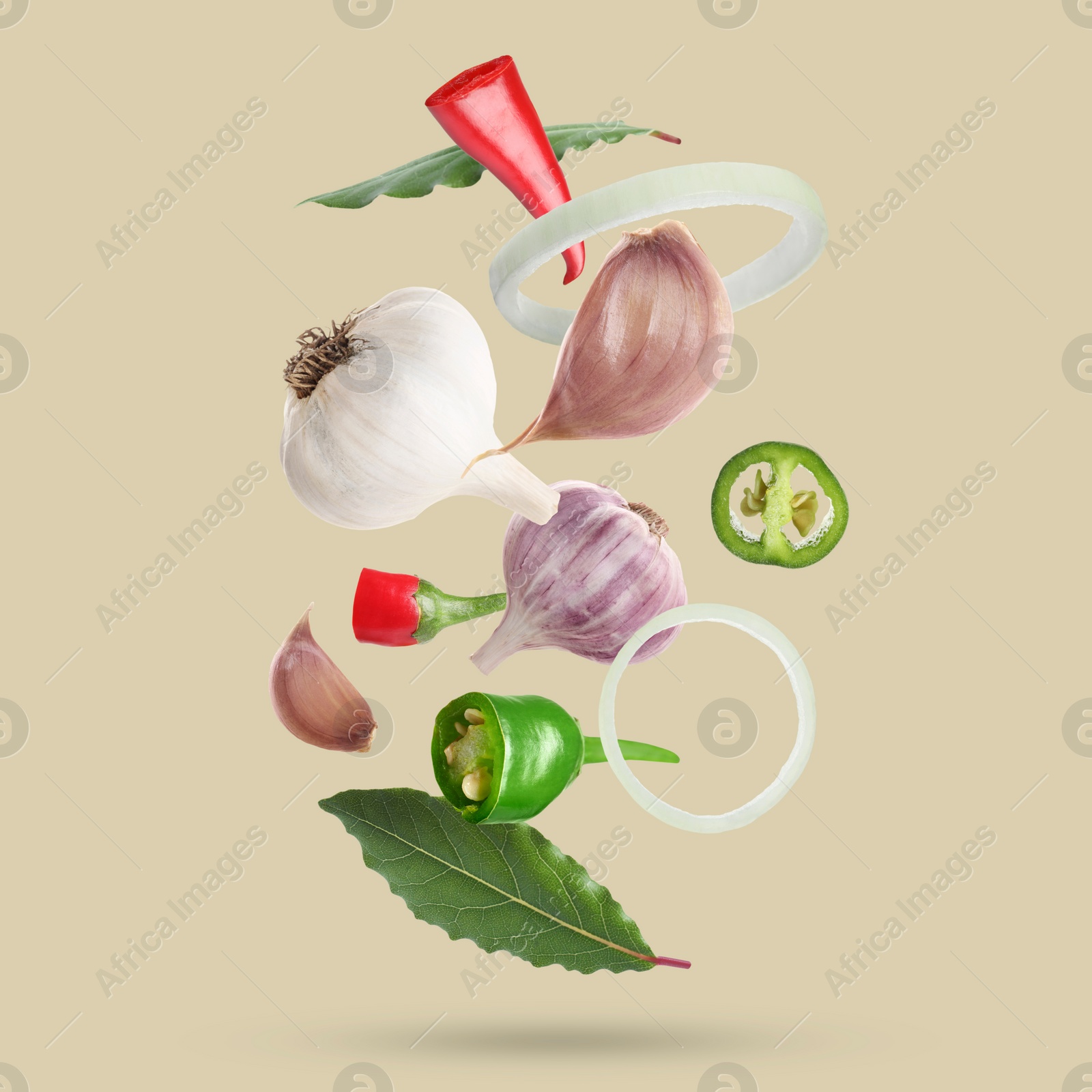 Image of Different spices falling on dark beige background