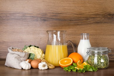 Photo of Food high in calcium. Different products on wooden table