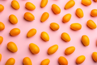 Photo of Fresh ripe kumquats on pink background, flat lay