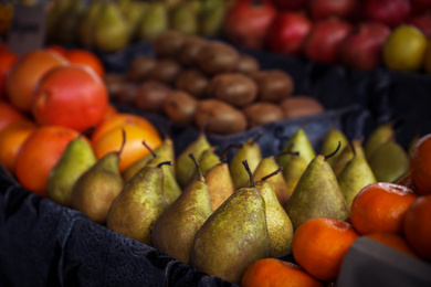 Photo of Tasty fresh fruits on counter at wholesale market, closeup
