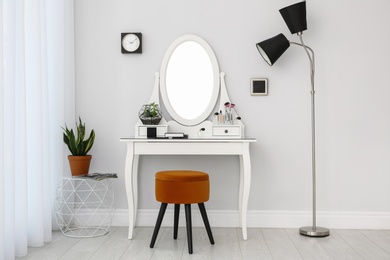 Photo of Dressing table with mirror in stylish room interior