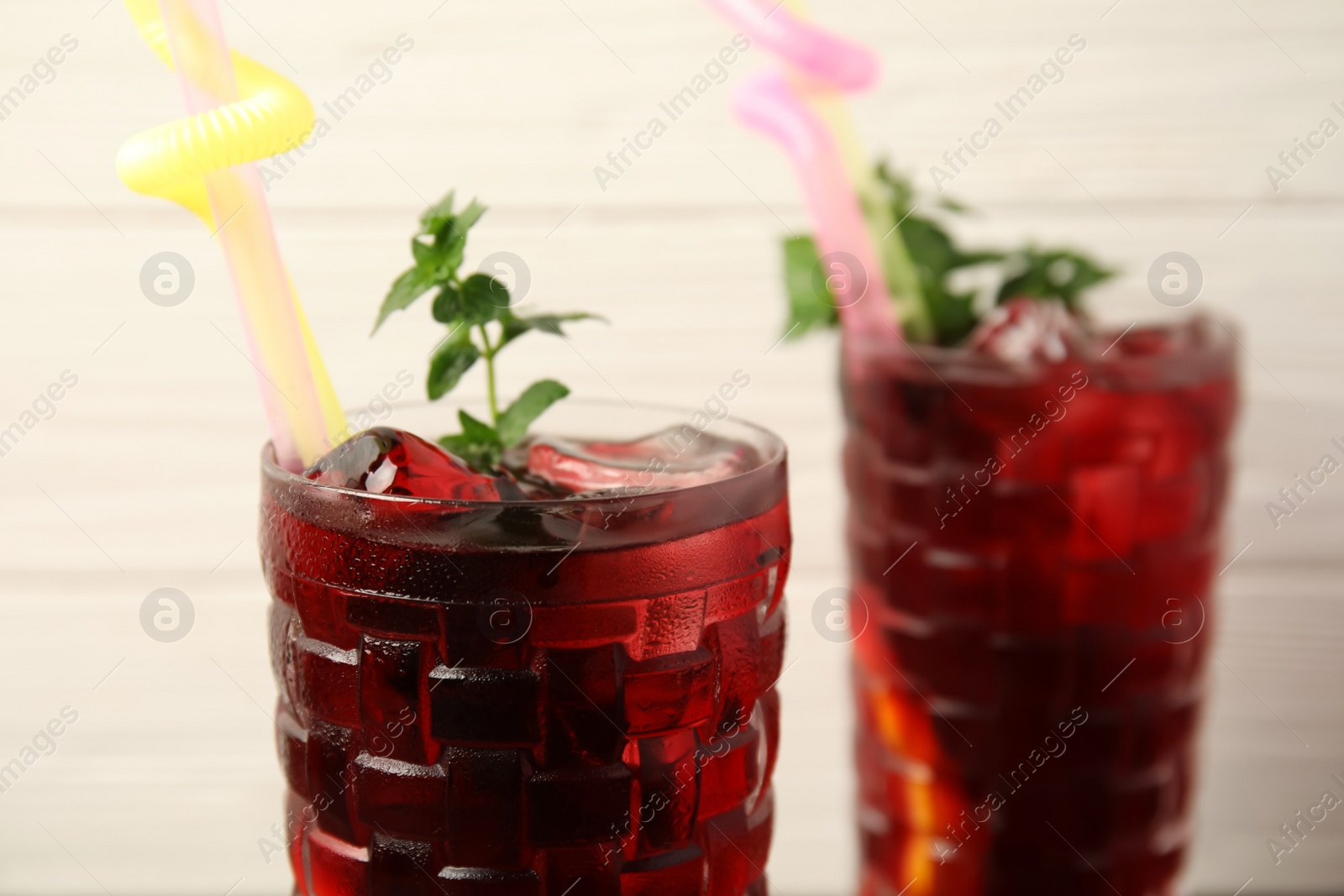 Photo of Glass with delicious refreshing cocktail, closeup