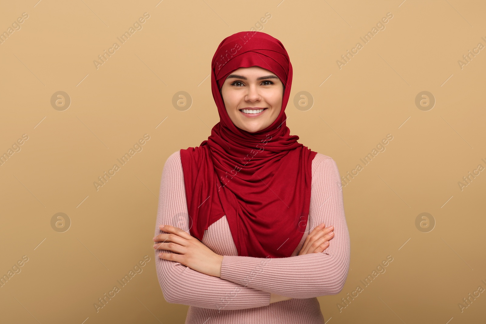 Photo of Portrait of Muslim woman in hijab on beige background