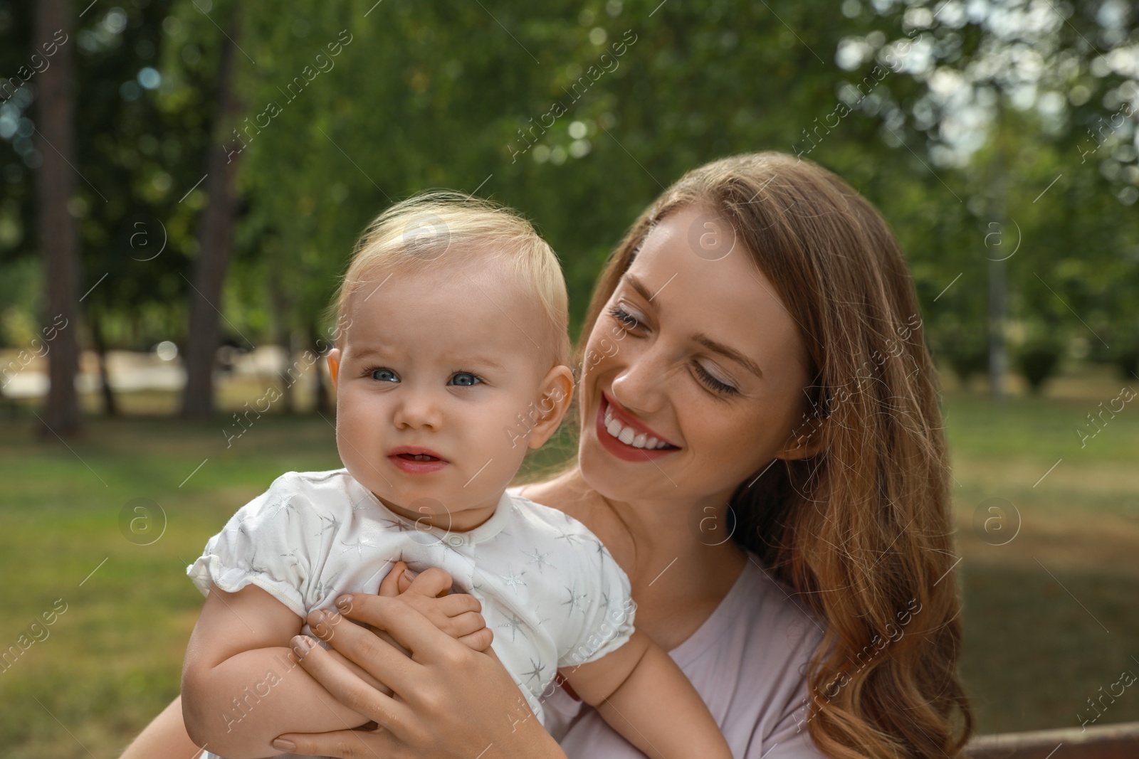 Photo of Mother with her cute baby spending time together outdoors