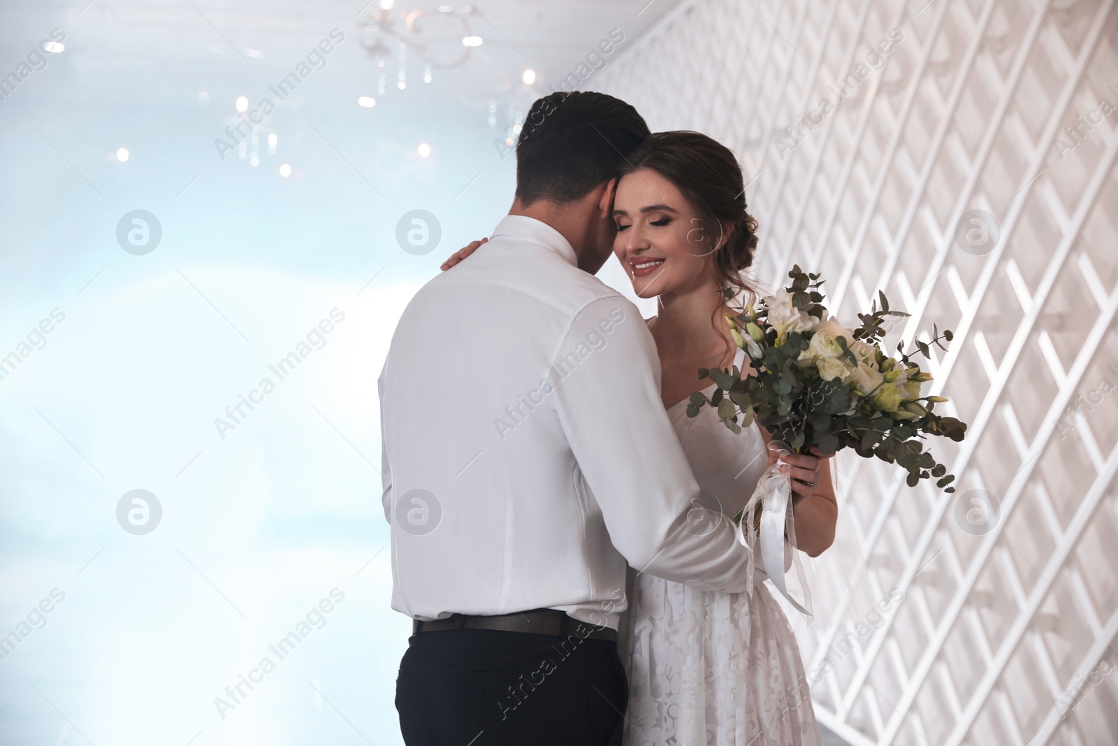 Photo of Happy newlywed couple dancing together in festive hall