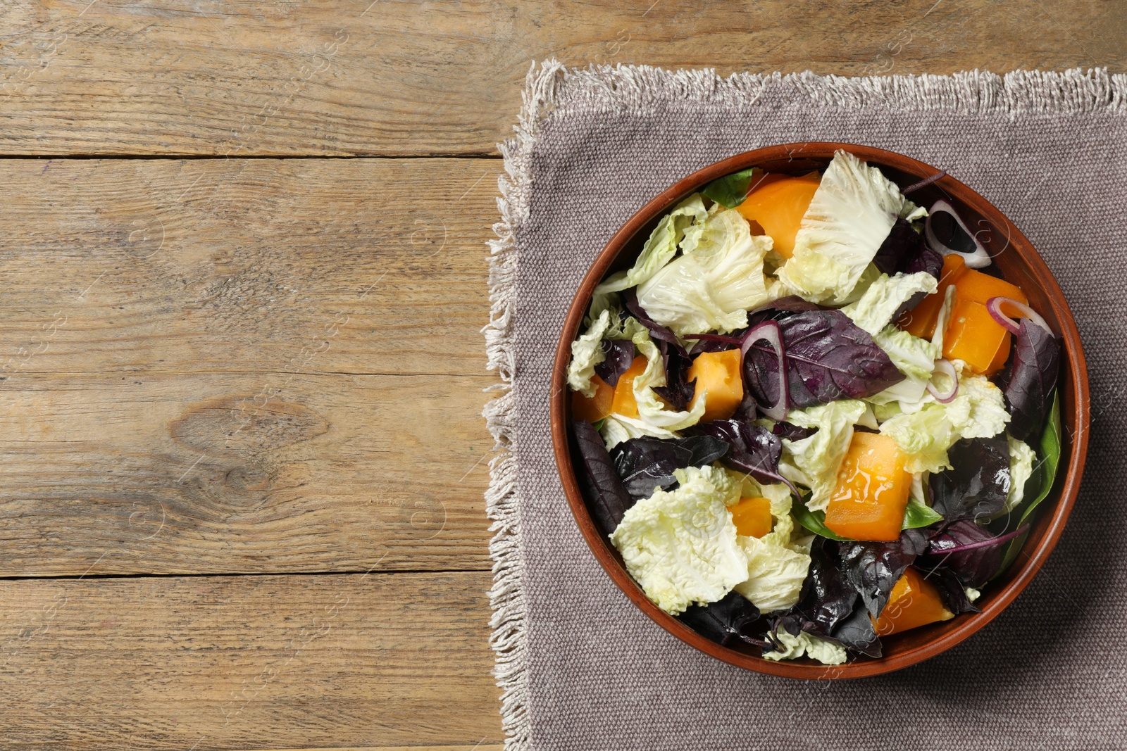 Photo of Delicious salad with Chinese cabbage, tomato and basil on wooden table, top view. Space for text