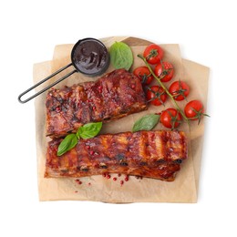Photo of Tasty roasted pork ribs, basil, sauce and tomatoes isolated on white, top view