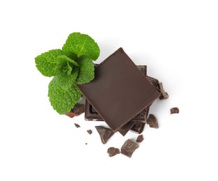 Photo of Tasty dark chocolate pieces with mint on white background, top view