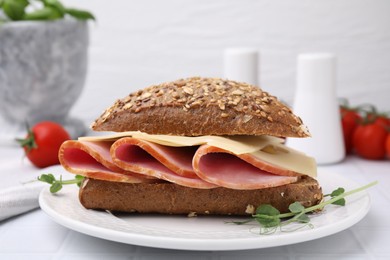 Photo of Delicious sandwich with ham and cheese on white table