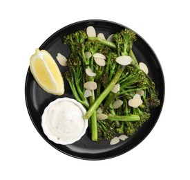 Photo of Tasty cooked broccolini with almonds, lemon and sauce isolated on white, top view