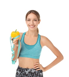 Photo of Happy slim woman with bell pepper and measuring tape on white background. Weight loss diet