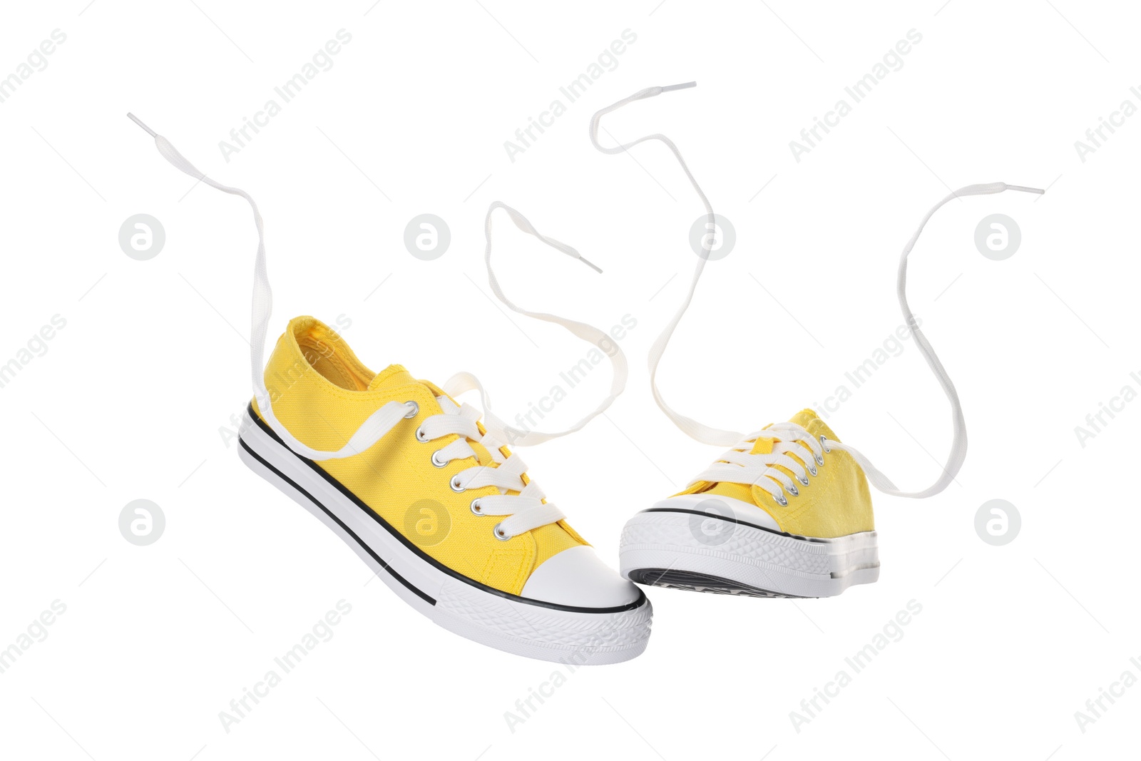 Photo of Pair of yellow classic old school sneakers on white background