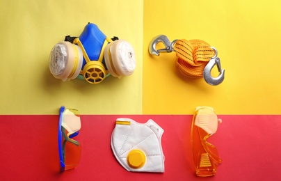 Photo of Flat lay composition with safety equipment on color background