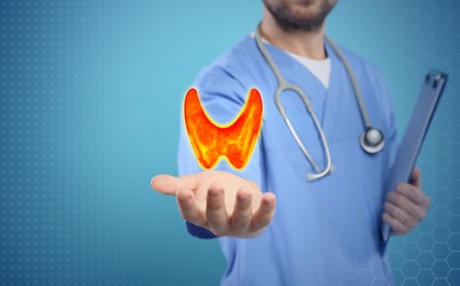 Image of Diagnosis and treatment of thyroid diseases. Endocrinologist holding virtual unhealthy gland on light blue background, space for text
