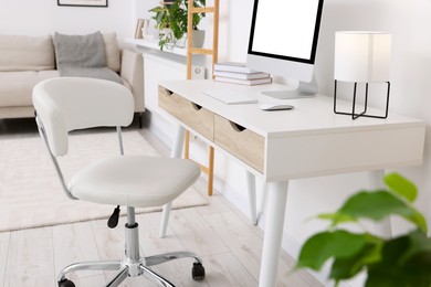 Photo of Workplace with comfortable office chair indoors. Interior design