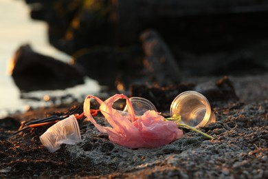 Photo of Plastic garbage at beach, space for text. Environmental pollution concept