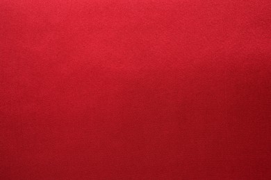 Photo of Texture of beautiful red silk fabric as background, closeup