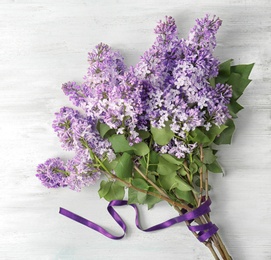 Beautiful blossoming lilac on light background, top view. Spring flowers